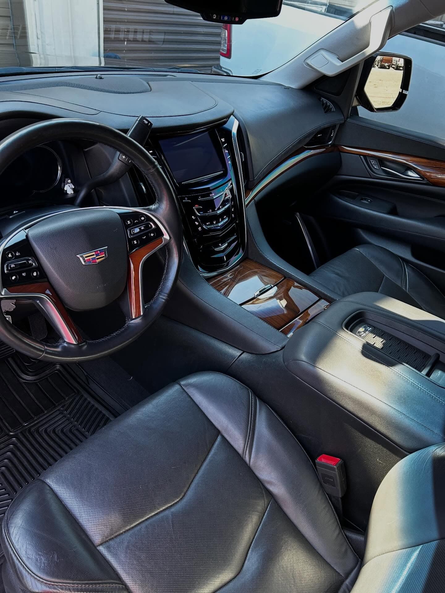 Detailed Cadillac Escalade interior with polished leather and wood trim