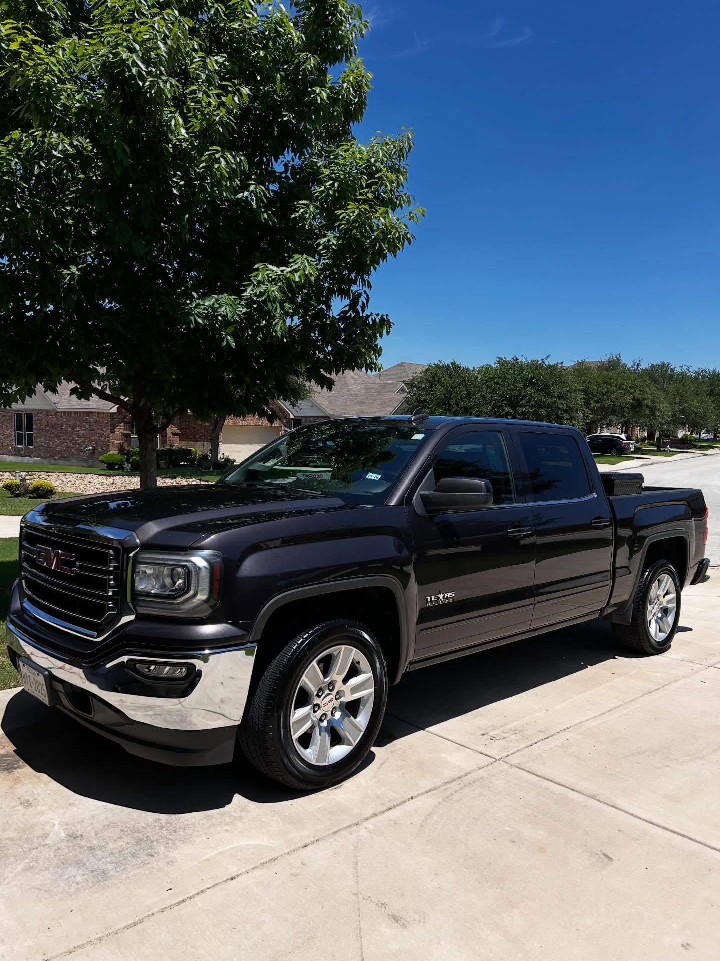 Glossy dark GMC Sierra after exterior detailing